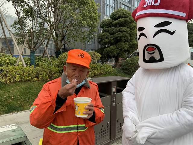 粥大白将腊八粥送至环卫工人们的手中